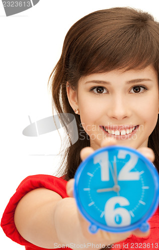 Image of teenage girl holding alarm clock
