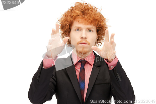 Image of businessman working with something imaginary