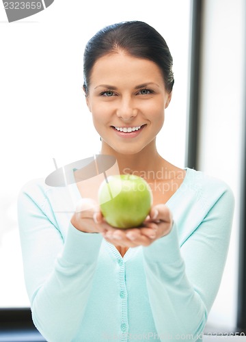 Image of lovely housewife with green apple