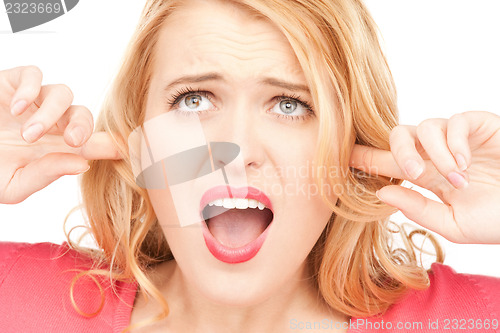 Image of woman with fingers in ears