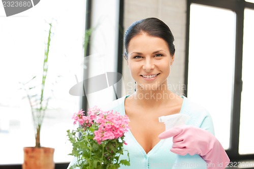 Image of lovely housewife with flower