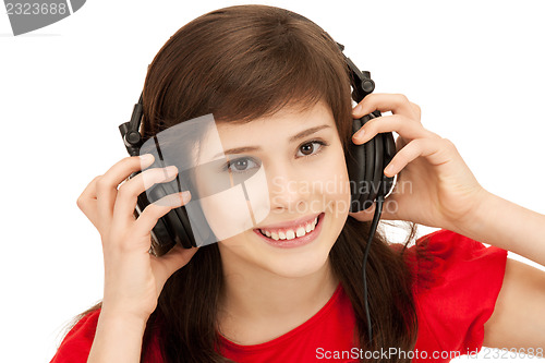 Image of happy teenage girl in big headphones