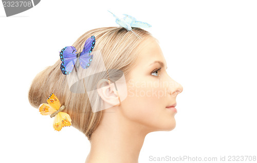 Image of beautiful woman with butterfly in hair