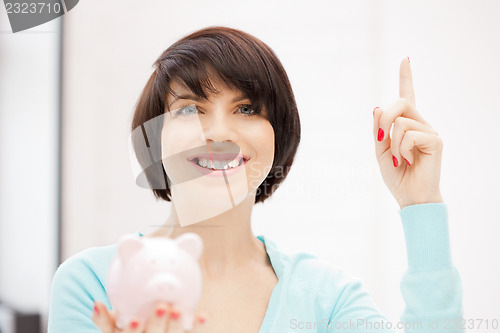 Image of lovely woman with piggy bank
