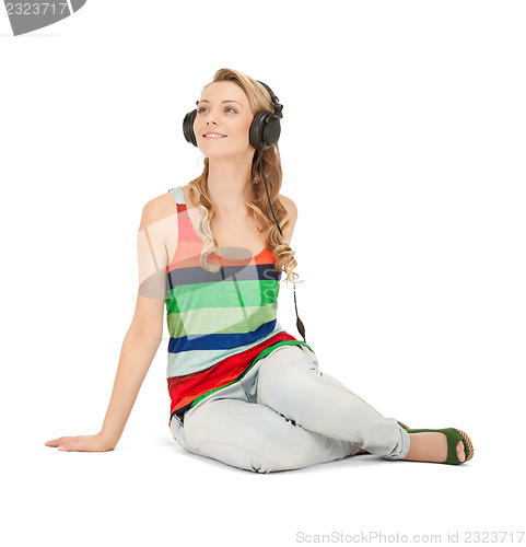 Image of happy teenage girl in big headphones
