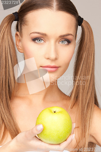 Image of young beautiful woman with green apple