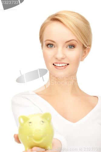 Image of lovely woman with piggy bank