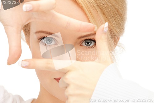 Image of lovely woman creating a frame with fingers