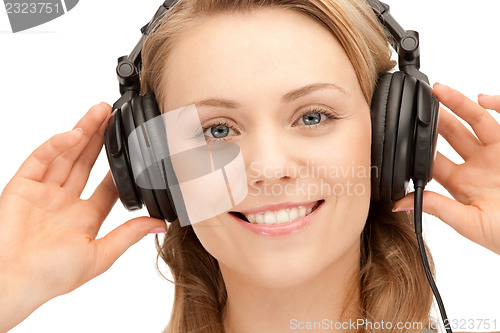 Image of happy teenage girl in big headphones