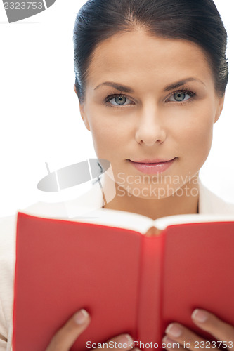 Image of calm and serious woman with book