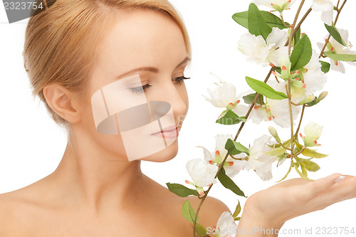 Image of beautiful woman with orchid flower