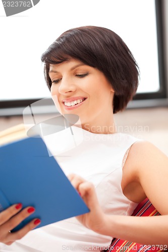 Image of happy and smiling woman with book