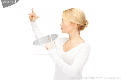 Image of businesswoman working with something imaginary