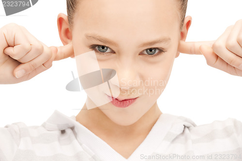 Image of teenage girl with fingers in ears