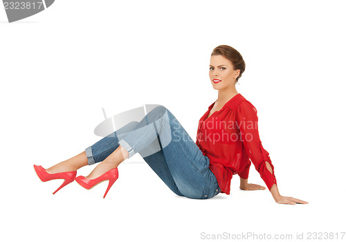 Image of lovely woman in red blouse and jeans