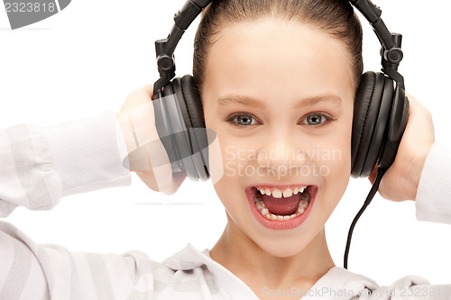 Image of happy teenage girl in big headphones