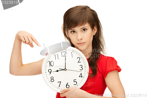 Image of teenage girl holding big clock