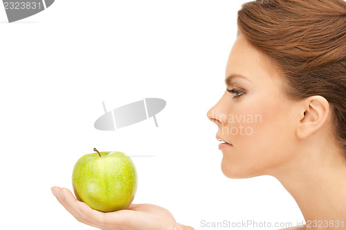Image of young beautiful woman with green apple