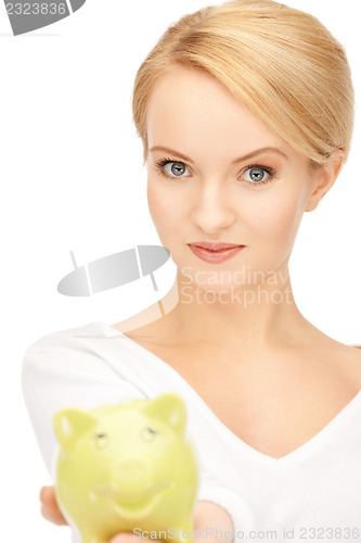 Image of lovely woman with piggy bank