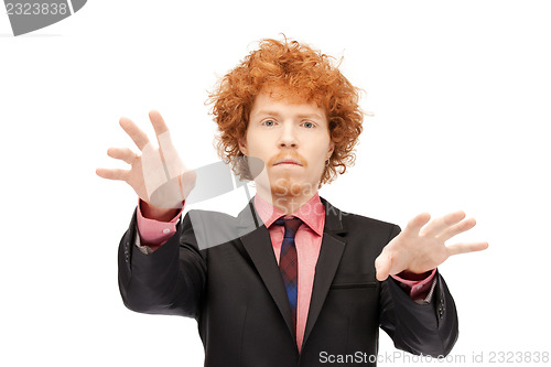 Image of businessman working with something imaginary