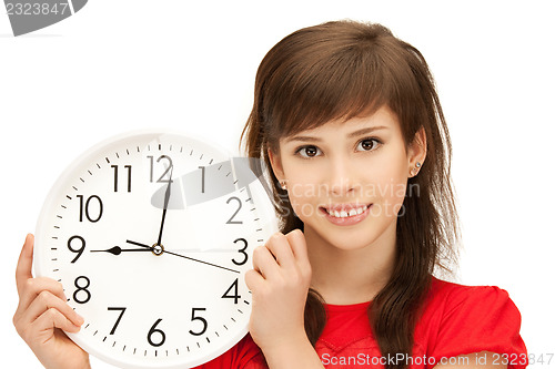 Image of teenage girl holding big clock