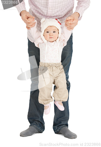 Image of baby hanging on fathers hands