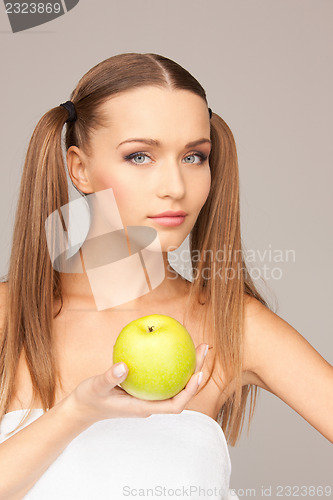 Image of young beautiful woman with green apple