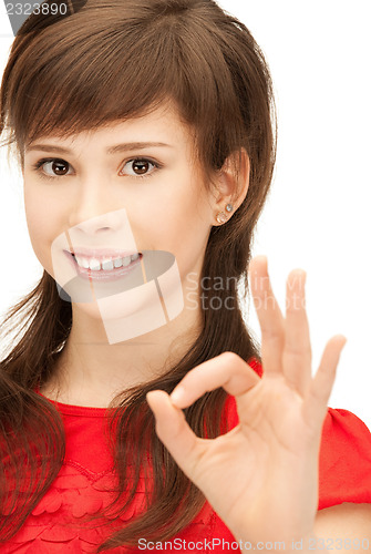 Image of lovely teenage girl showing ok sign