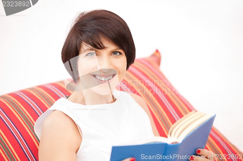 Image of happy and smiling woman with book