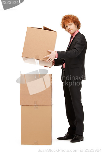 Image of attractive businessman with big boxes