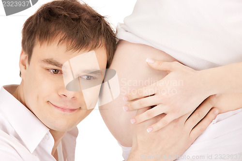 Image of male face and pregnant woman belly