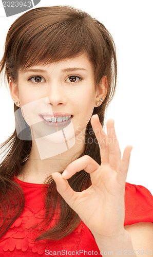 Image of lovely teenage girl showing ok sign