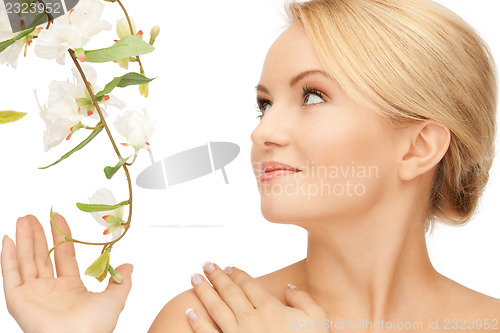 Image of beautiful woman with orchid flower
