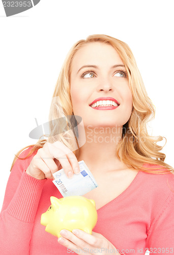 Image of lovely woman with piggy bank and money