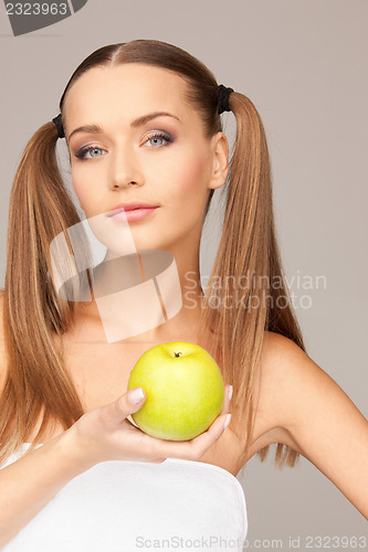 Image of young beautiful woman with green apple