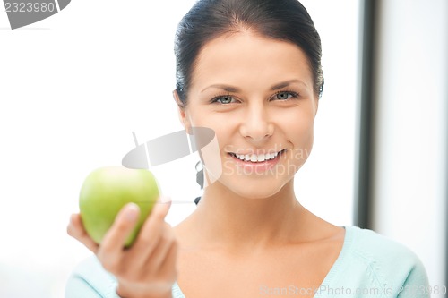 Image of lovely housewife with green apple
