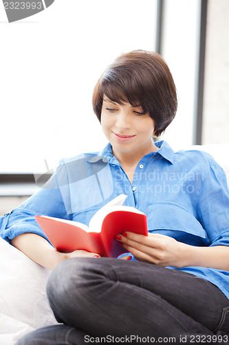Image of happy and smiling woman with book