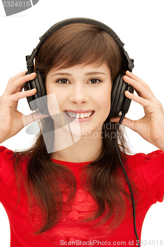 Image of happy teenage girl in big headphones