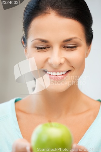 Image of lovely housewife with green apple