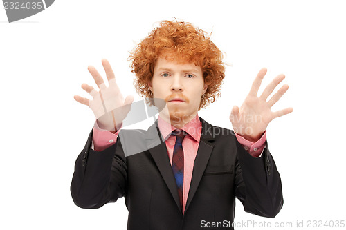 Image of businessman working with something imaginary