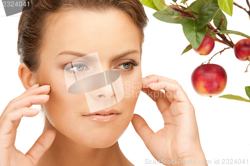 Image of lovely woman with apple twig