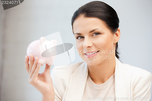 Image of lovely woman with piggy bank