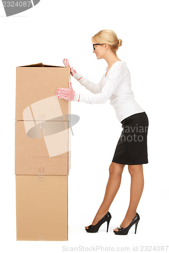 Image of attractive businesswoman with big boxes