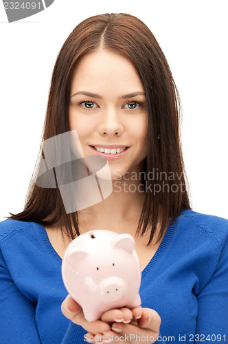 Image of lovely woman with piggy bank