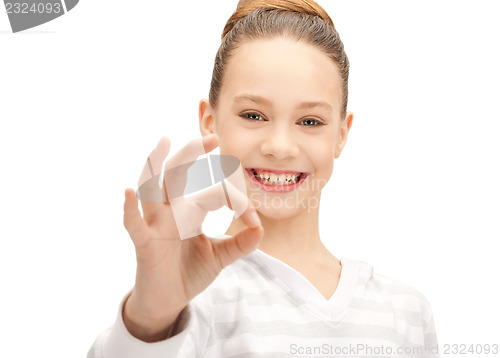 Image of lovely teenage girl showing ok sign
