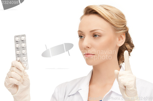 Image of attractive female doctor with pills