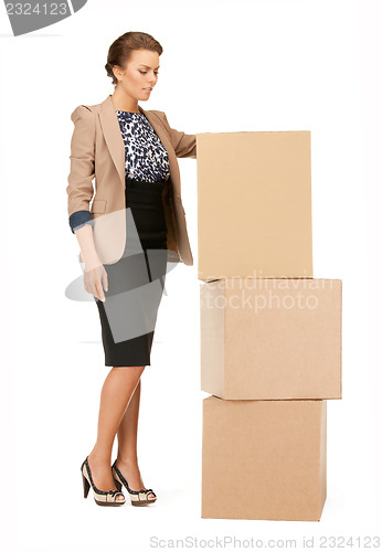 Image of attractive businesswoman with big boxes