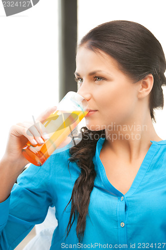 Image of beautiful woman with glass of juice
