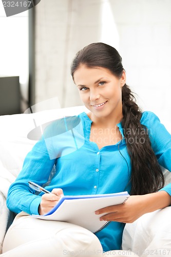 Image of happy woman with big notepad