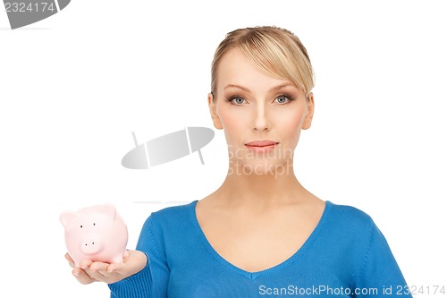 Image of lovely woman with piggy bank